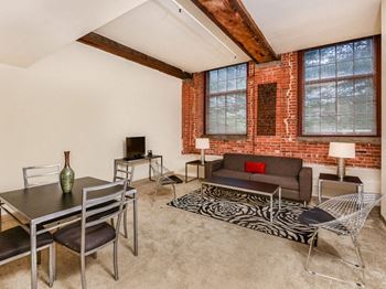 A living room with a couch table and chairs